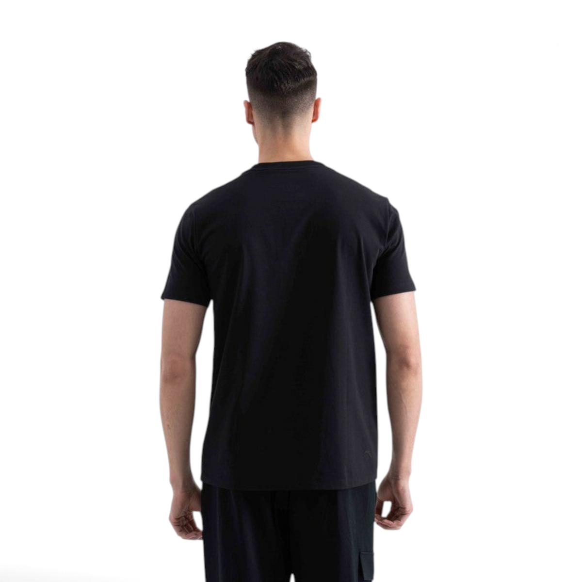 Back view of a man wearing a plain black short-sleeve crew neck t-shirt from FRG
