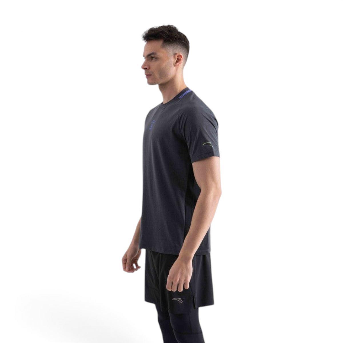 A man wearing a FRG charcoal grey short-sleeve athletic t-shirt with blue accents, side view.