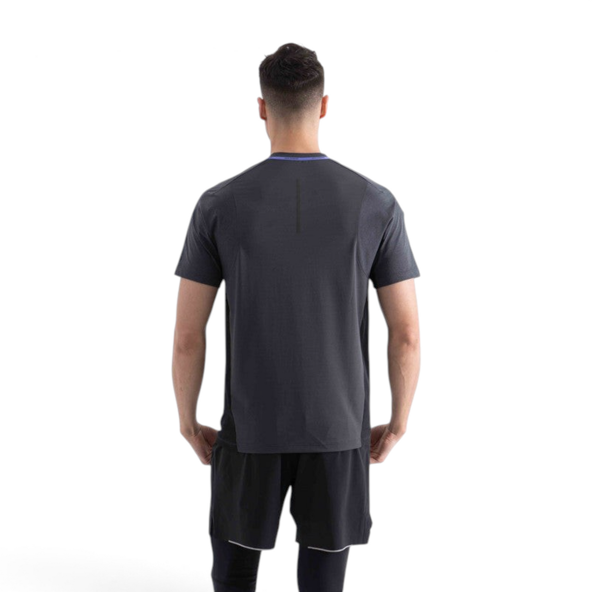 Back view of a man wearing a dark grey FRG SS TEE performance shirt with a purple neck detail.