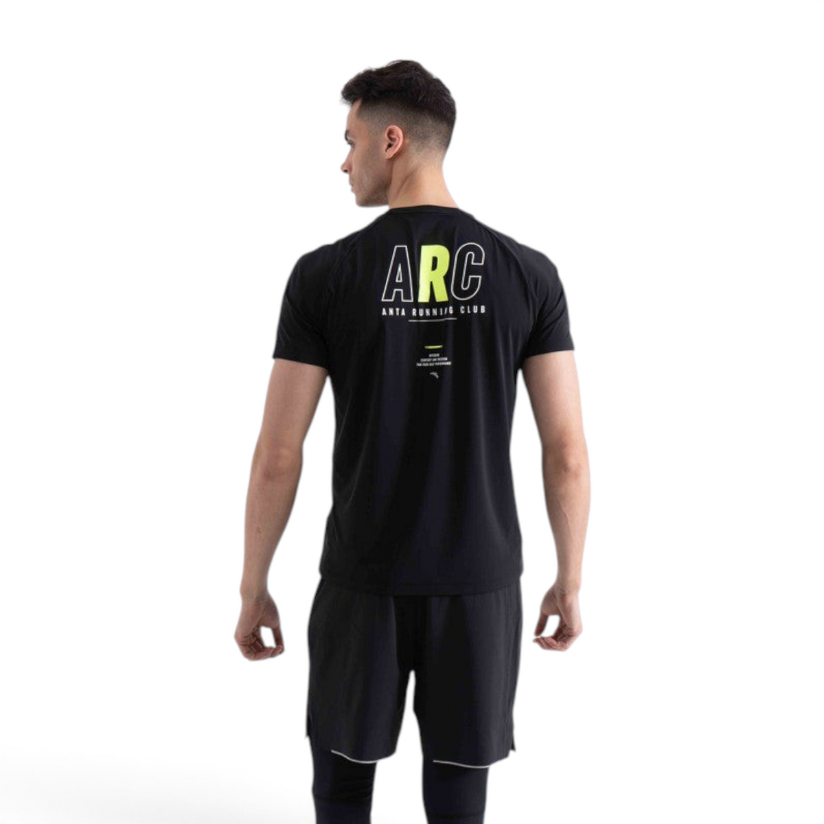 A man wearing a black FRG short-sleeve running t-shirt with ARC Anta Running Club graphic on the back