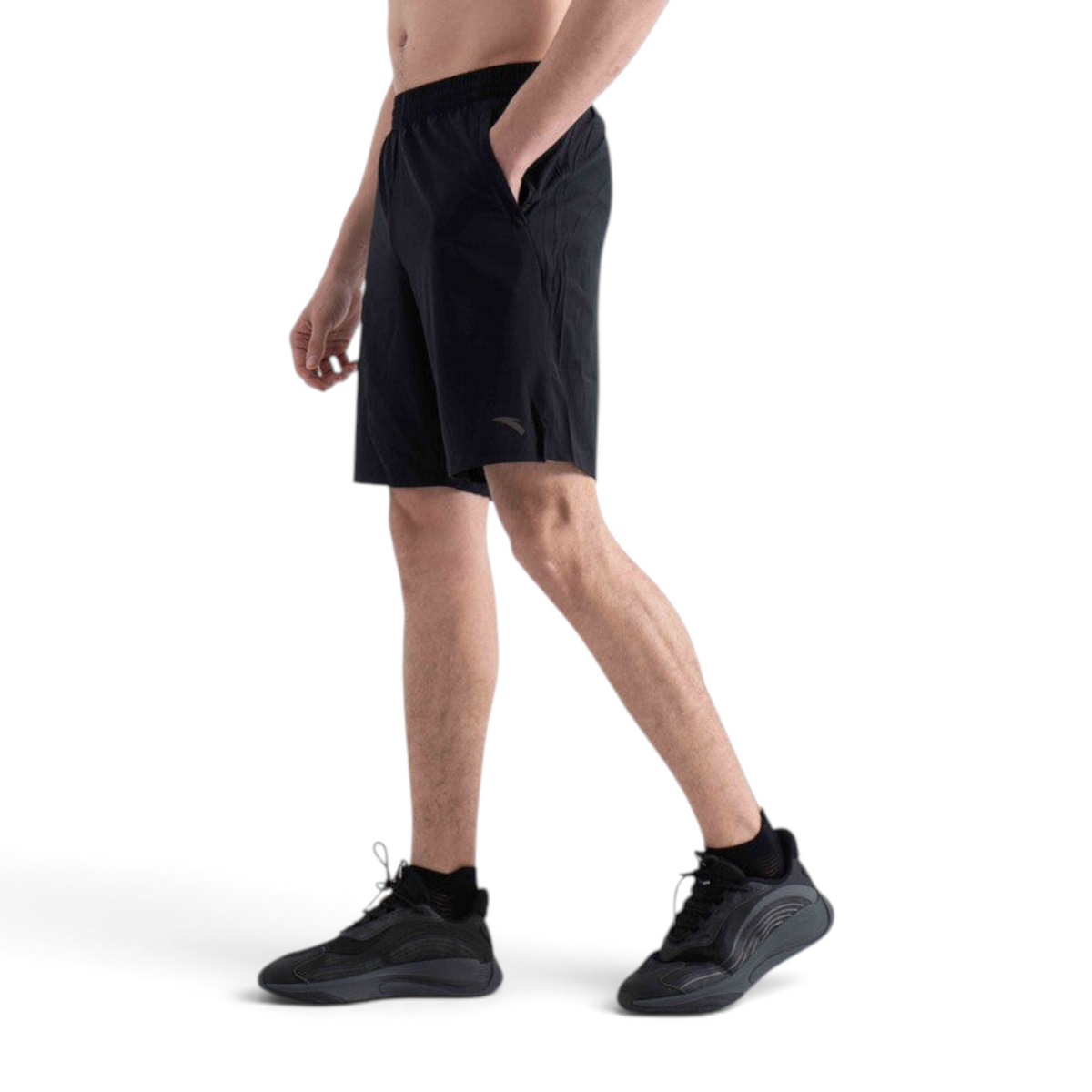 FRG black athletic shorts with an elastic waistband and side pockets worn by a man against a white background