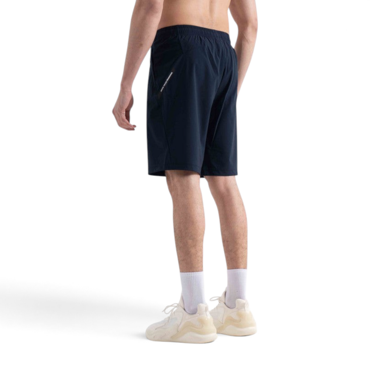 FRG navy knit half pants worn by a man from a back view, featuring an elastic waistband and athletic fit.