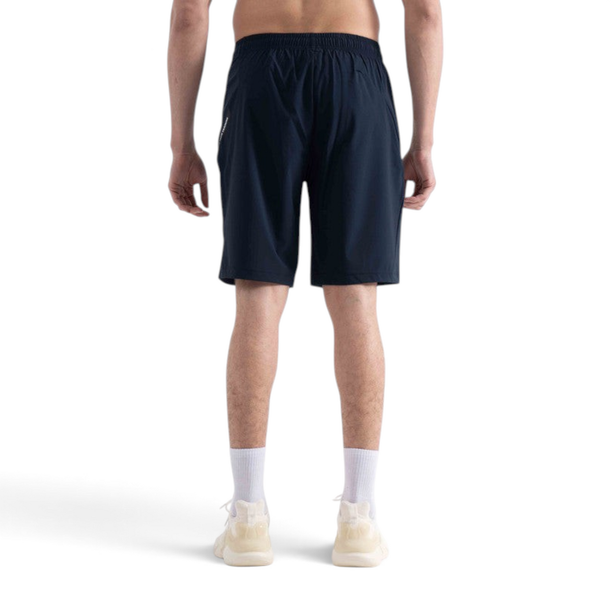 FRG knit half pants in navy blue worn by a man, back view showing athletic fit and elastic waistband