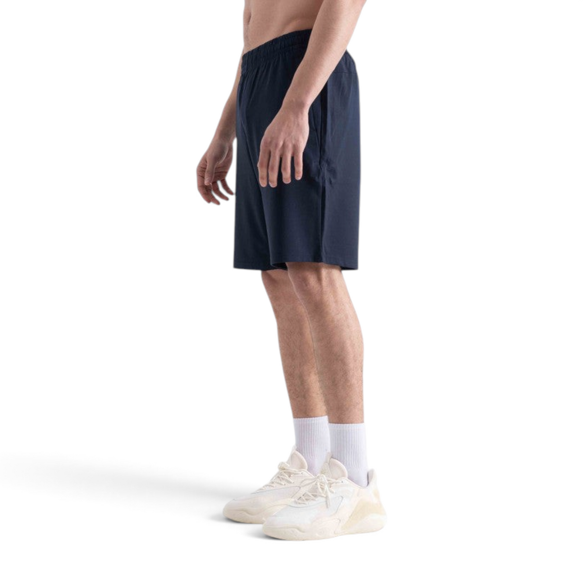 FRG navy knit half pants featuring an elastic waistband, worn by a man with white sneakers against a white background