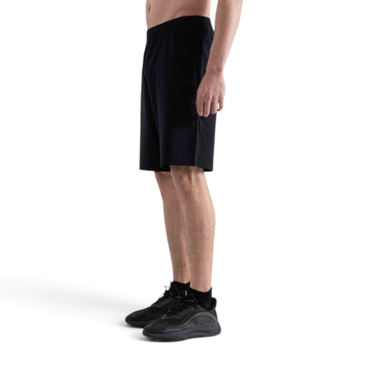 FRG black knit half pants worn by a man, featuring an elastic waistband and a comfortable athletic fit.
