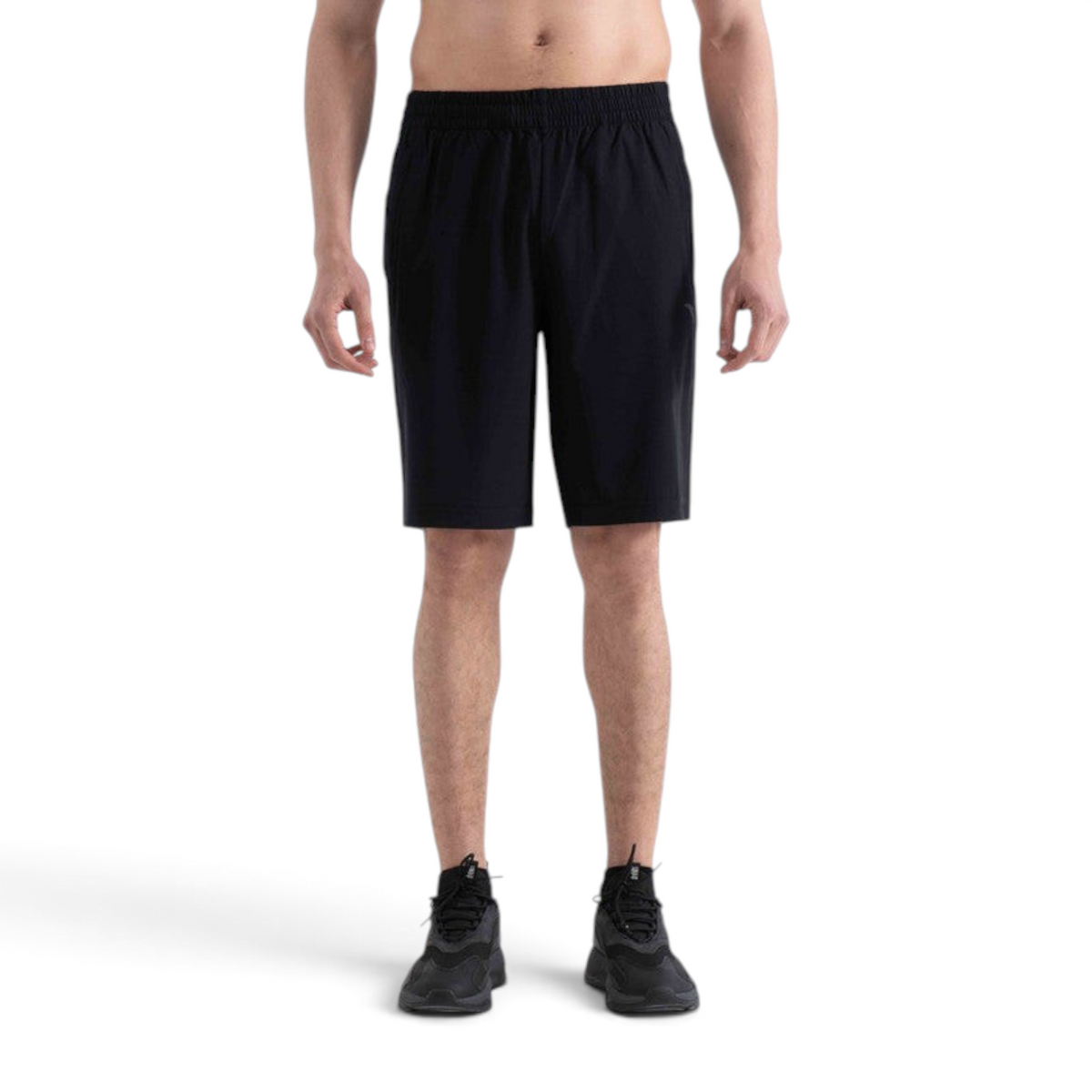 FRG black athletic half pants with an elastic waistband worn by a man against a white background