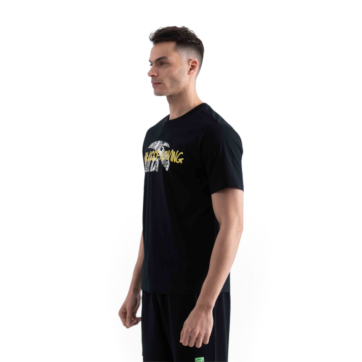 FRG black short sleeve t-shirt with Keep Moving graphic print worn by a man in profile view