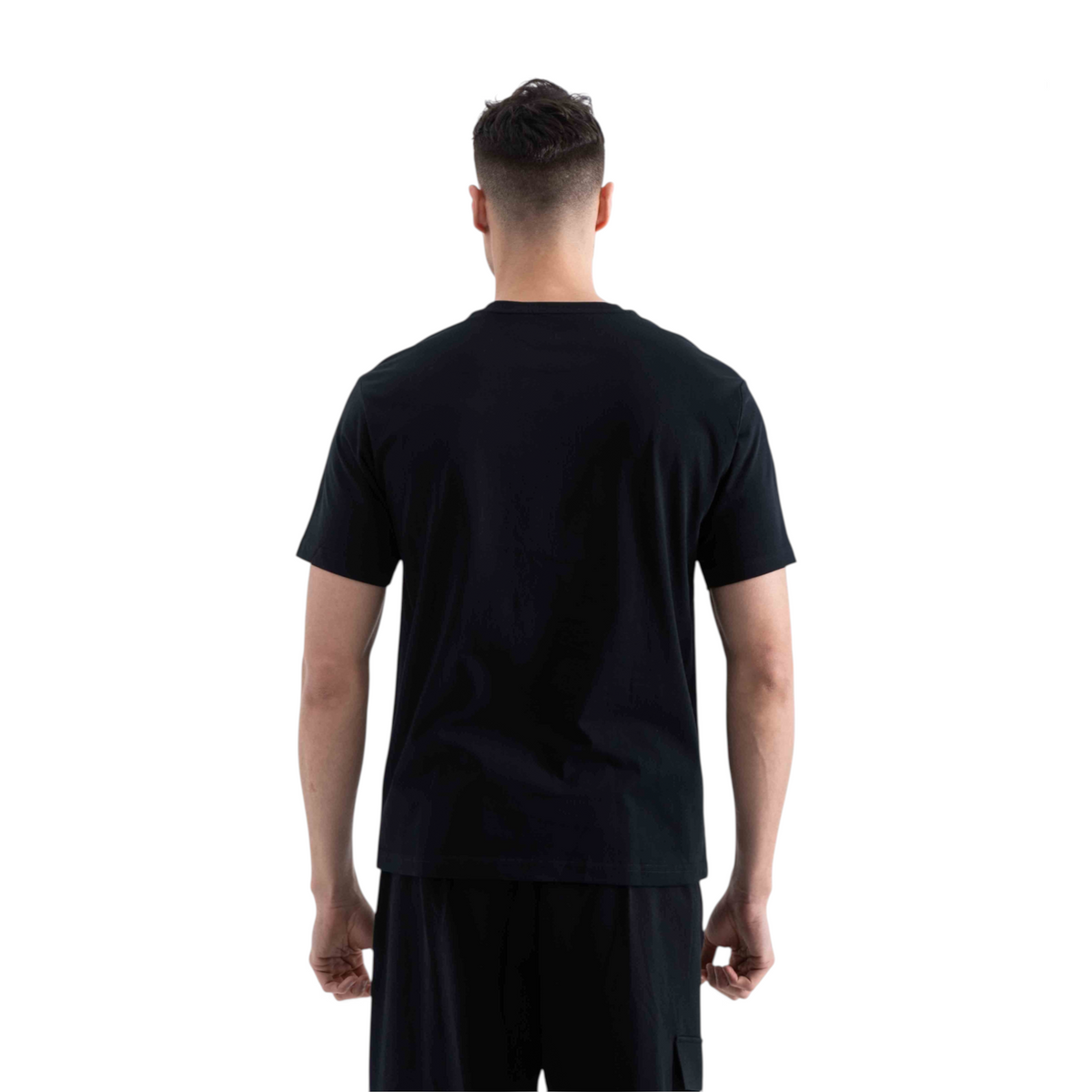 Back view of a man wearing a plain black short-sleeve crew neck t-shirt from FRG against a white background