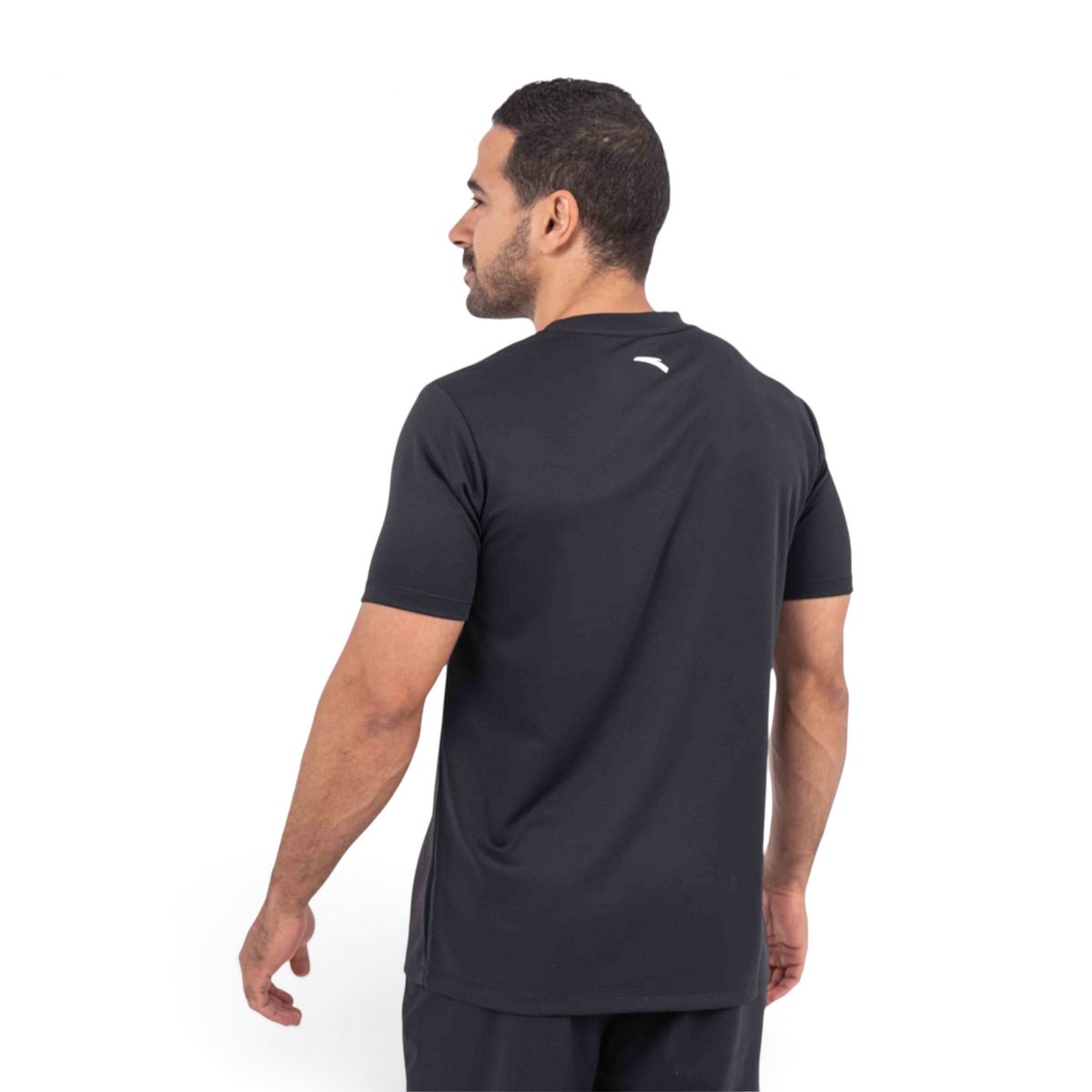 FRG black athletic t-shirt worn by a man, viewed from the back, featuring a small white logo on the upper neck.