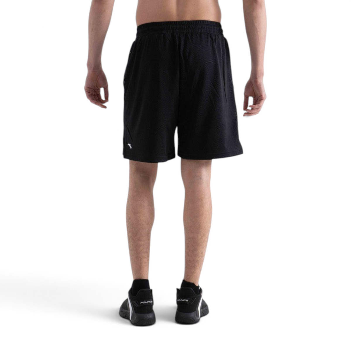 Back view of FRG black mesh basketball game shorts worn by a male athlete