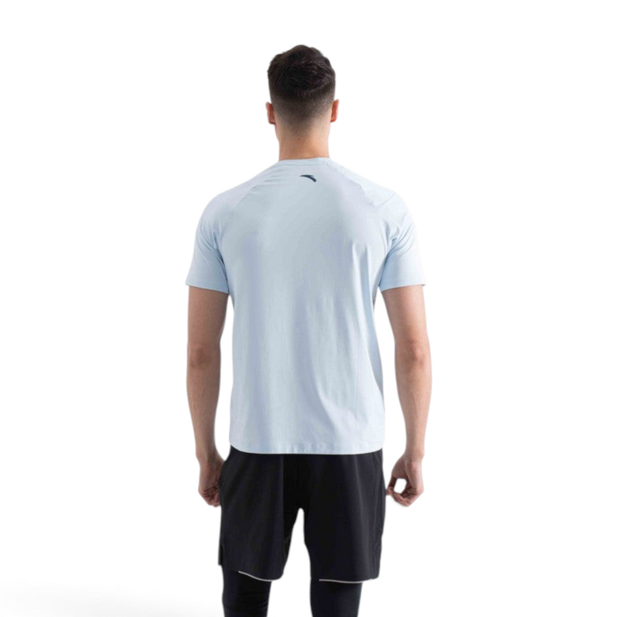 Back view of a man wearing a light blue FRG regular fit nylon spandex t-shirt with short sleeves