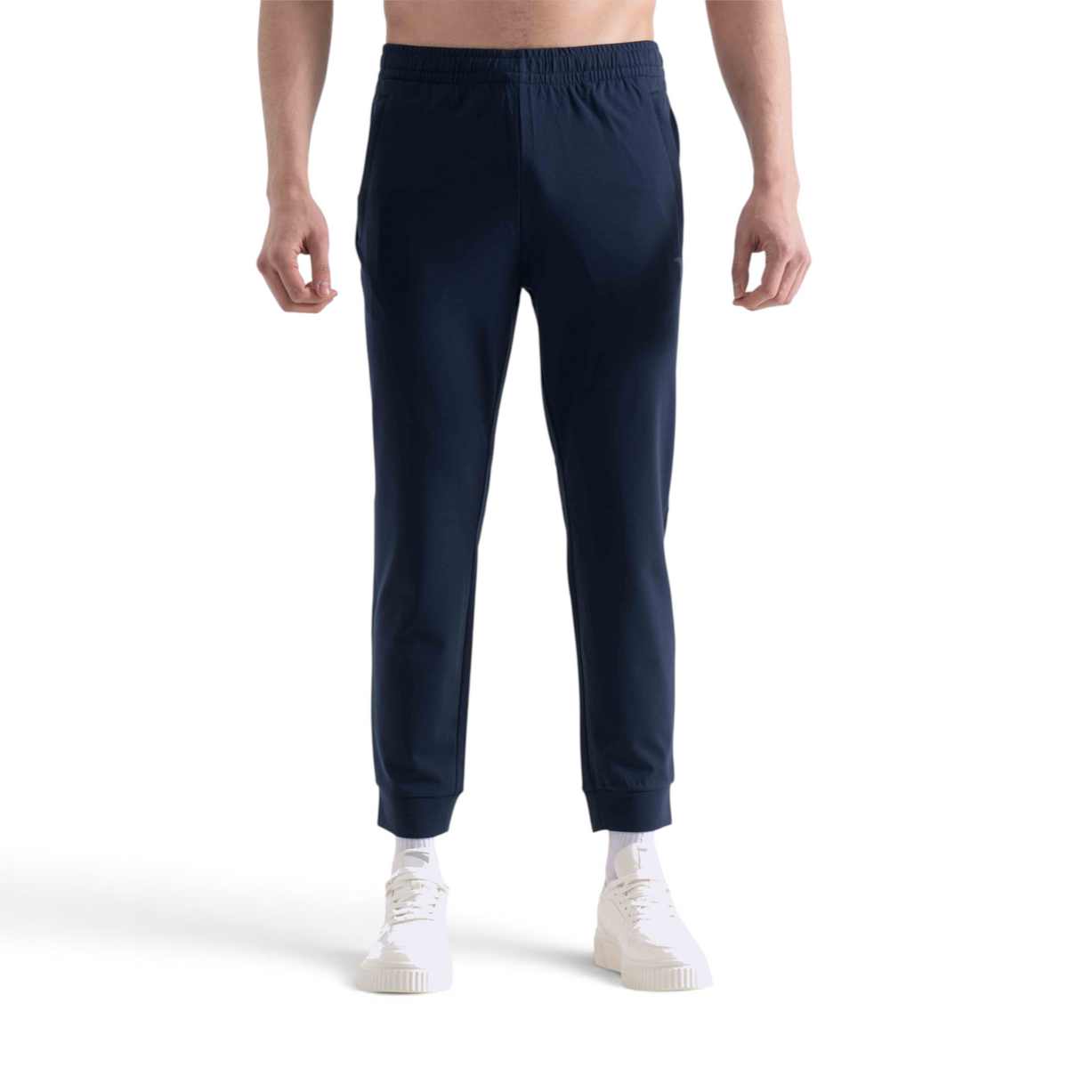 FRG slim fit navy blue knit ankle pants with an elastic waistband worn by a man with white sneakers