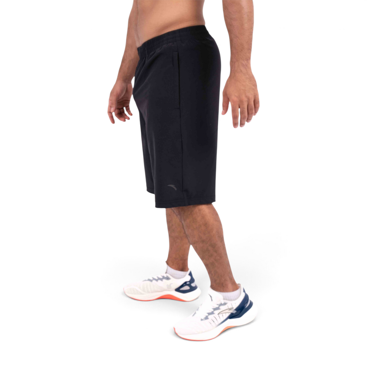 FRG black athletic shorts on a male model, side view, featuring an elastic waistband and lightweight fabric.