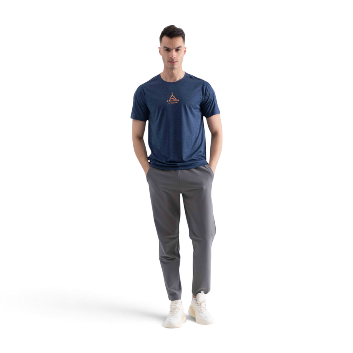 FRG cross training t-shirt in navy blue with a small orange graphic, worn by a man with grey trousers and sneakers.