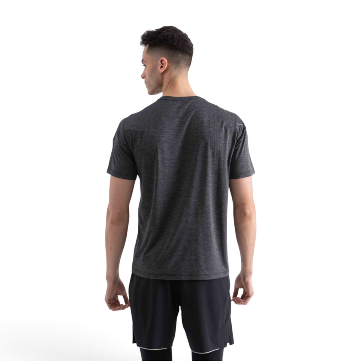 A man wearing a charcoal grey FRG SS TEE short-sleeve athletic shirt, viewed from the back against a white background.