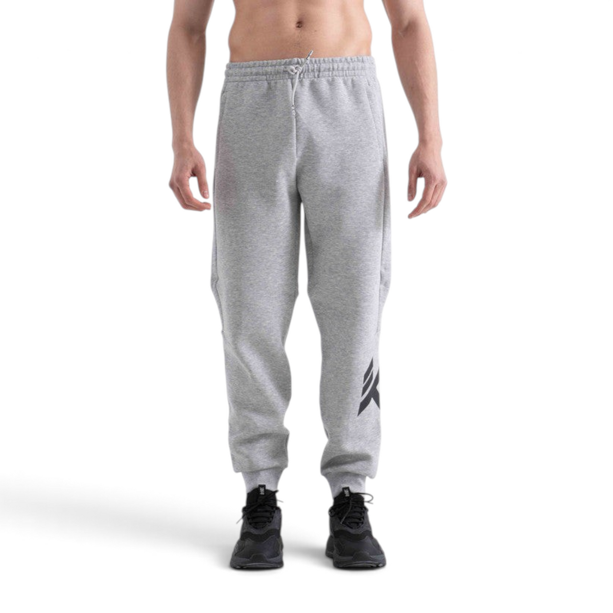 FRG knit track pants in light grey with a drawstring waist and black logo detail on the leg, worn by a man.