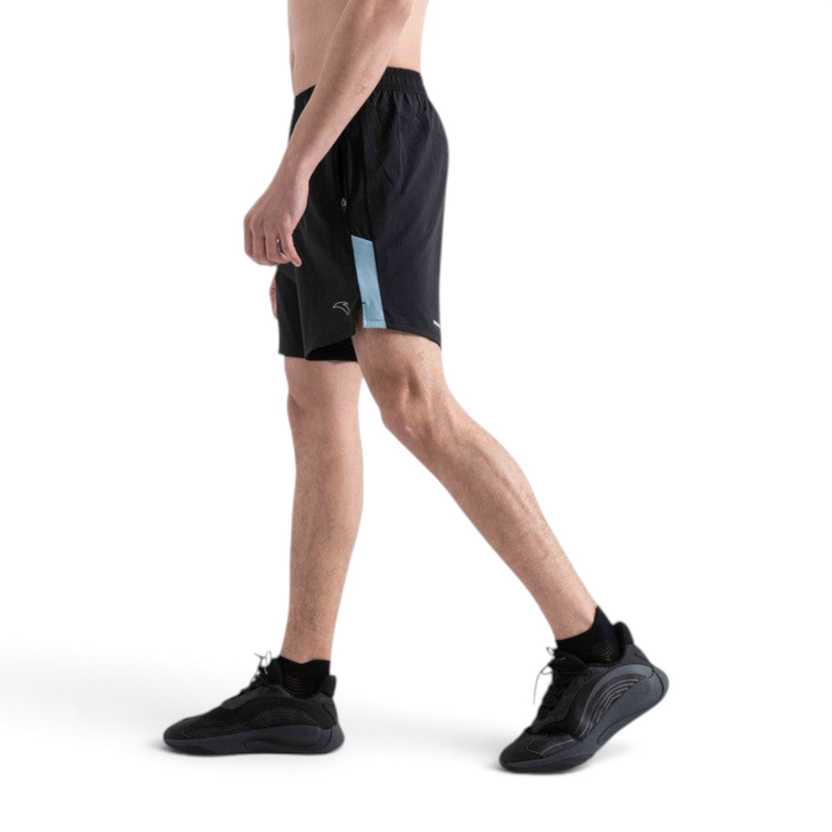 FRG black woven athletic shorts with light blue side panel detail worn by a man in a side profile view