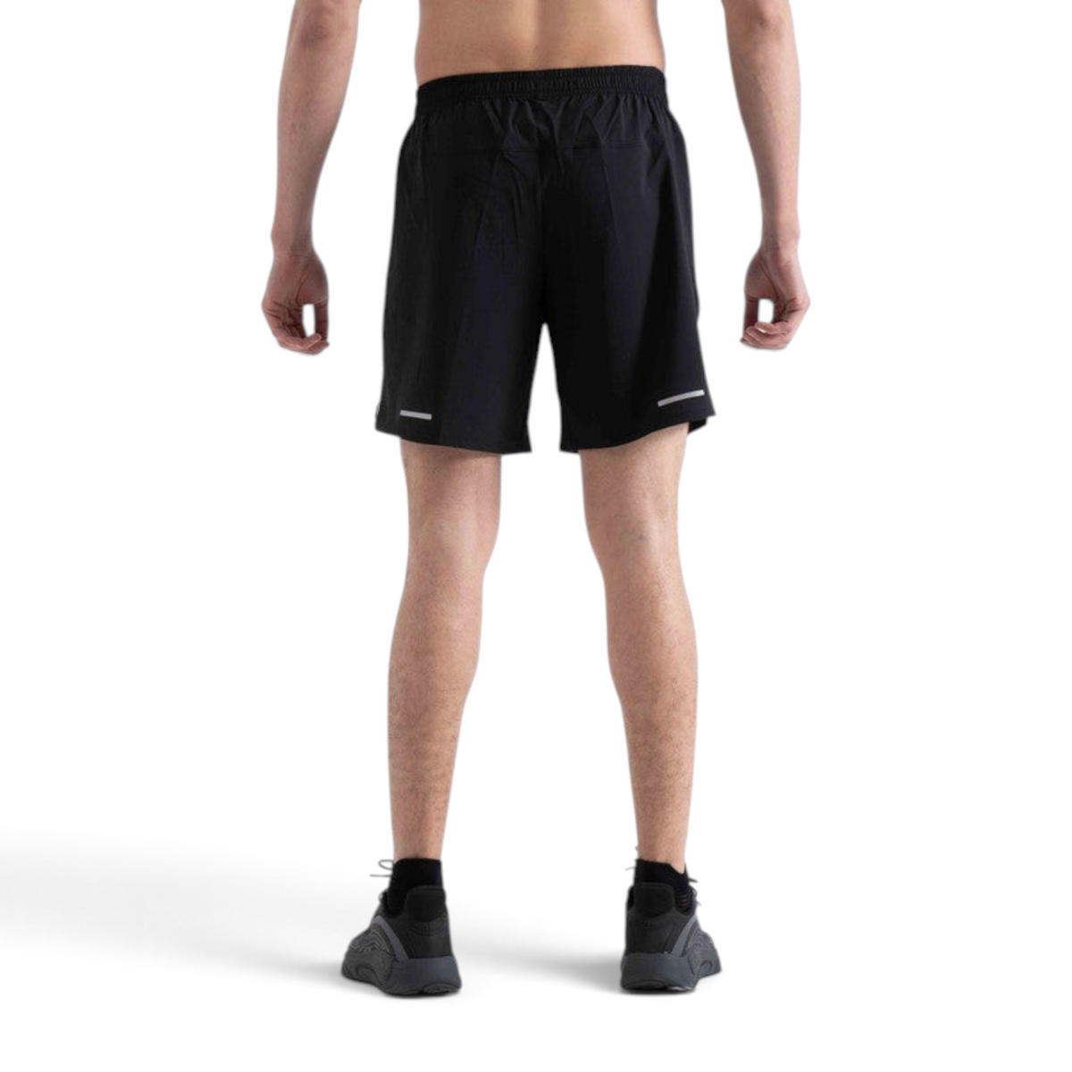 Back view of FRG black woven athletic shorts with reflective detailing on a male model