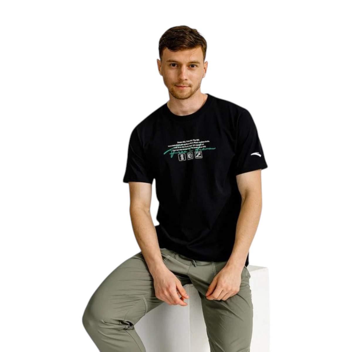 FRG ANTA Night Game black crew neck t-shirt with graphic print worn by a man sitting on a white block