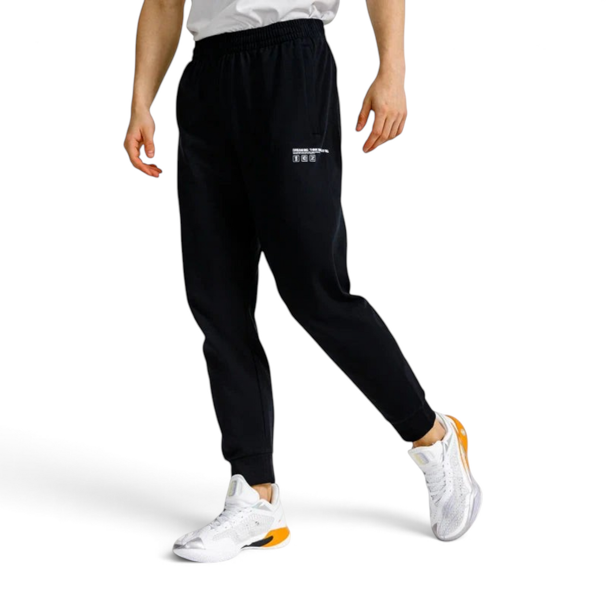 FRG ANTA black basketball knit track pants with elastic cuffs worn by a model with white athletic sneakers