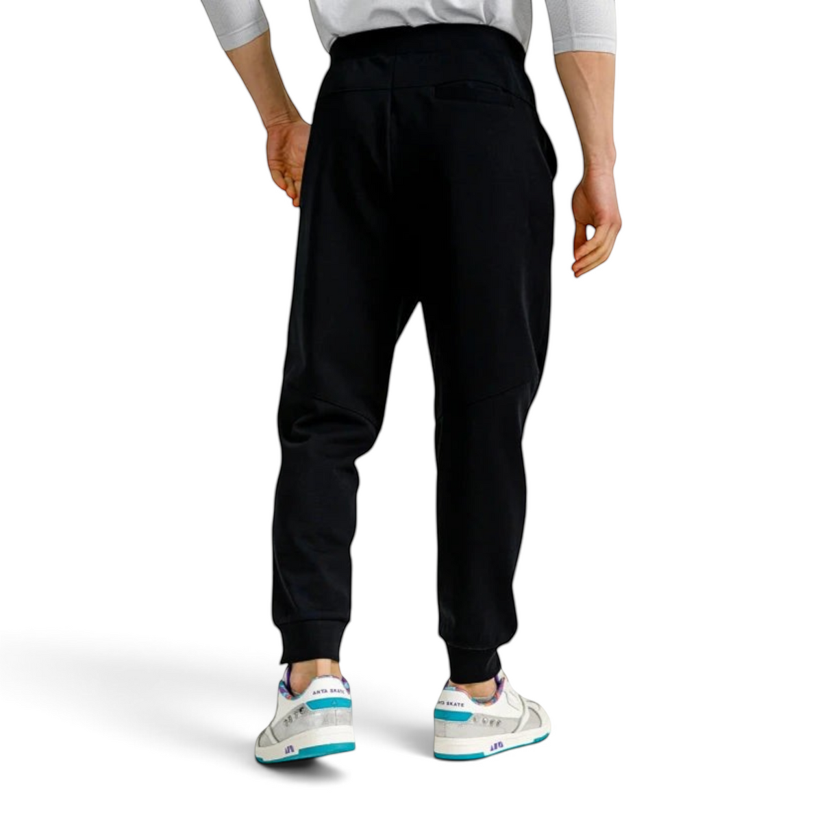 Back view of FRG ANTA knit track pants in black, featuring a comfortable fit and ribbed cuffs on a male model.
