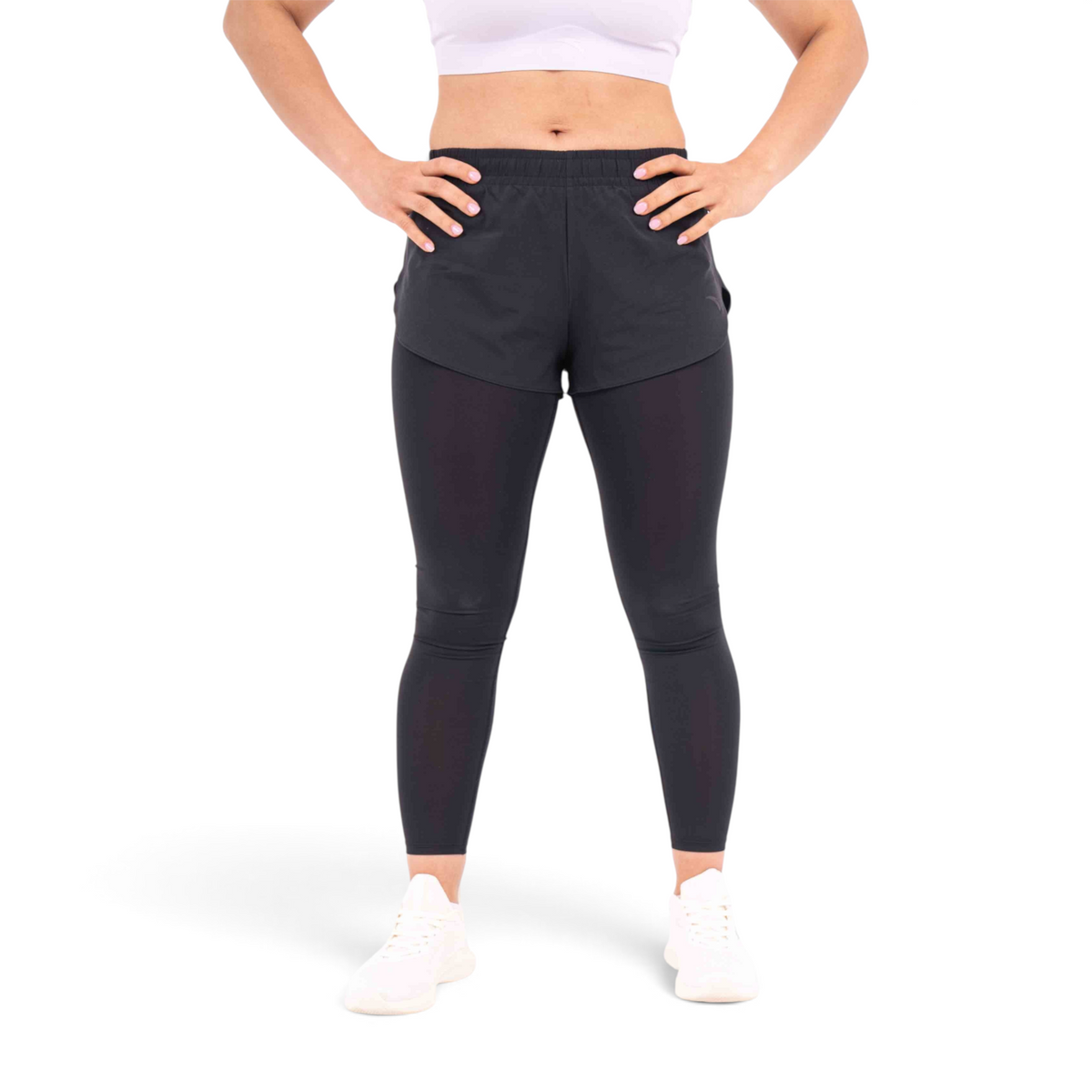 FRG black polyester athletic leggings with integrated shorts worn by a woman with hands on hips