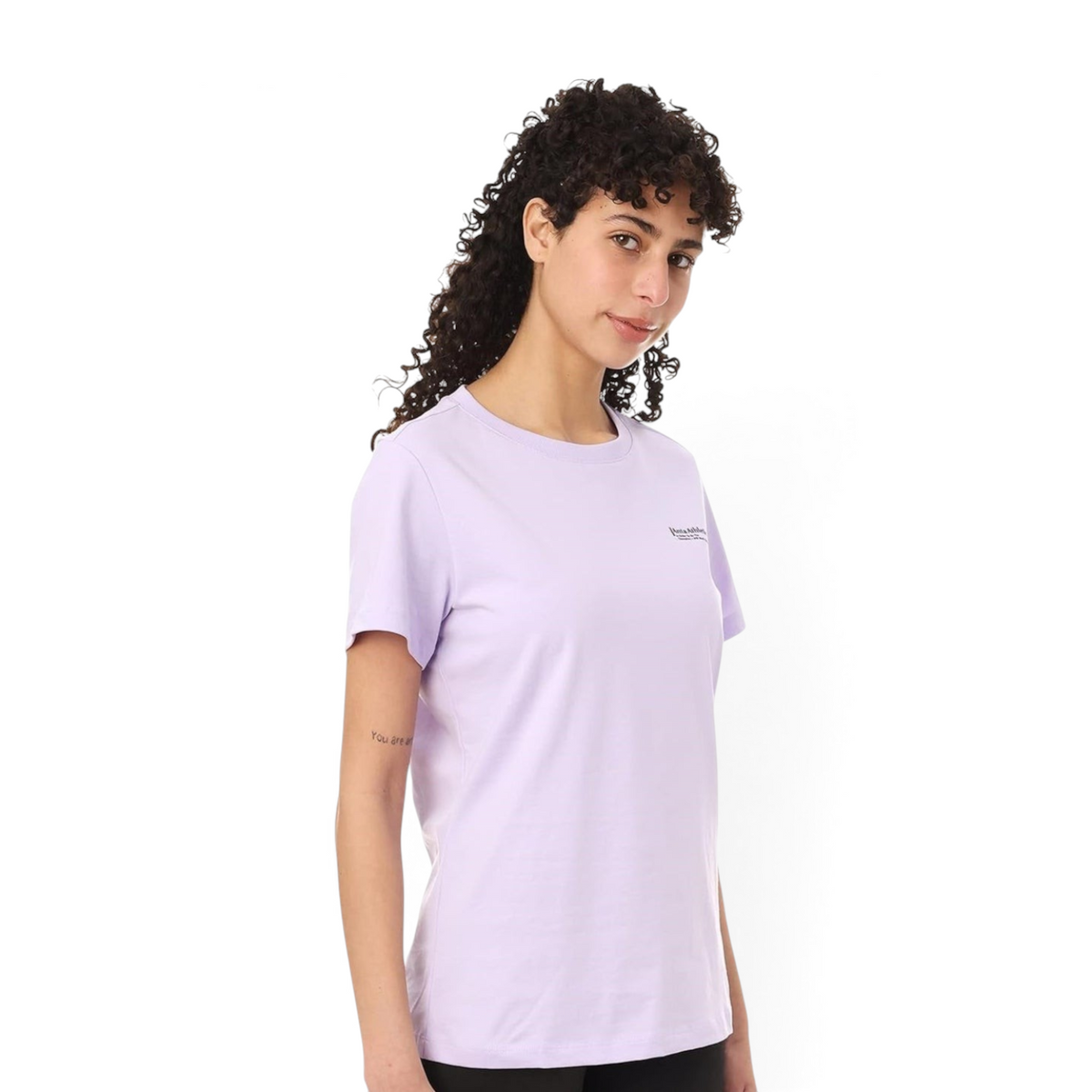 Model wearing a light purple FRG crew neck t-shirt with a small logo on the chest against a white background