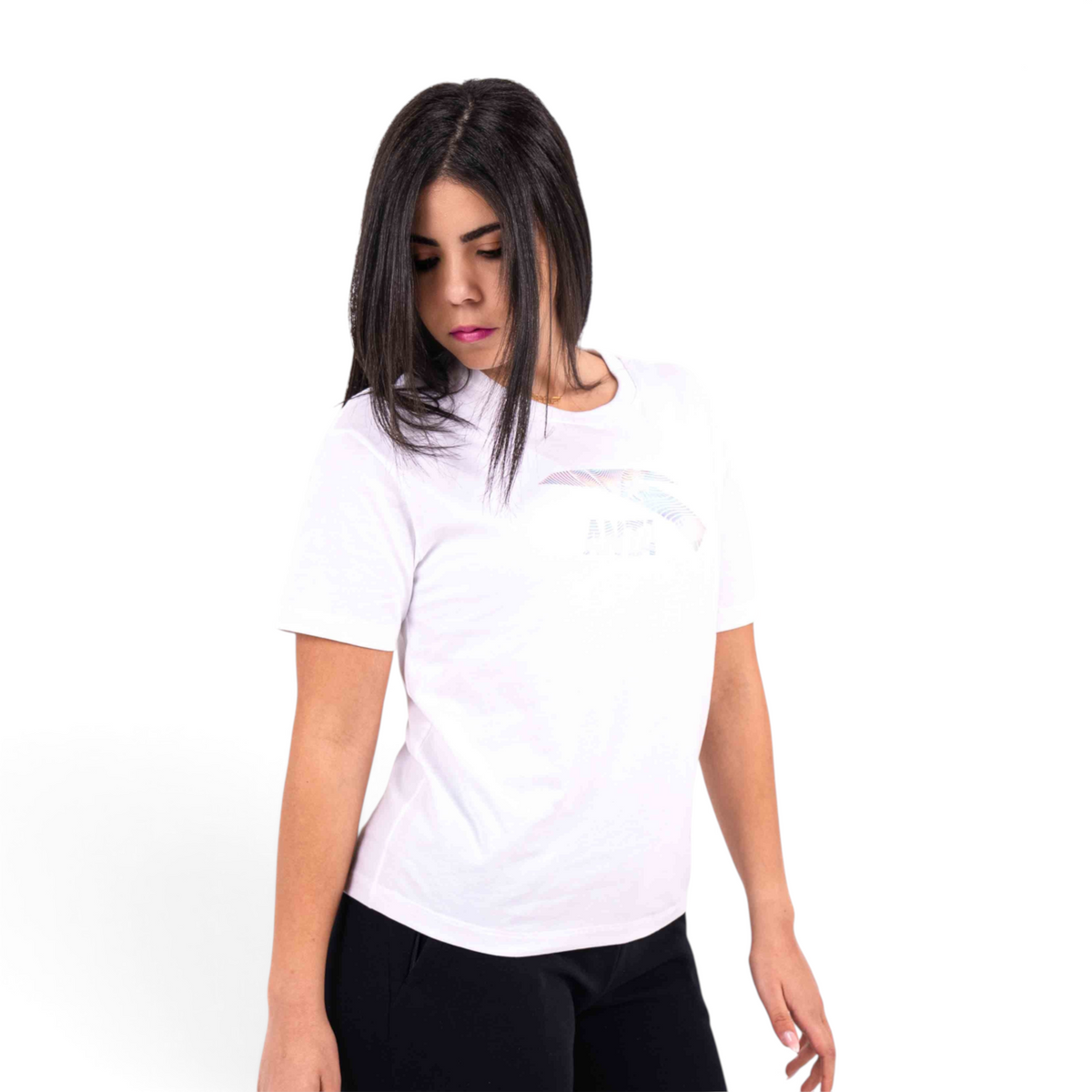 A woman wearing a white FRG crew neck t-shirt with a subtle graphic print on the chest, isolated on white background