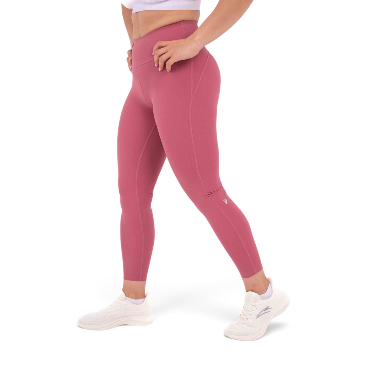 FRG slim fit tight ankle pants in dusty rose polyamide spandex blend worn by a model with white sneakers