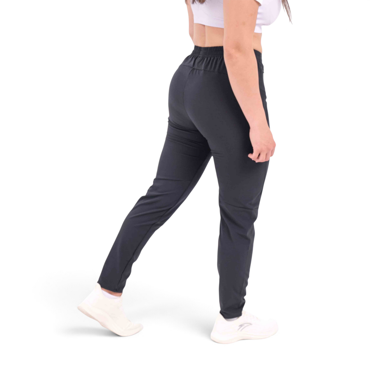 FRG slim fit black woven track pants made from polyester and spandex blend worn by a woman from the back view