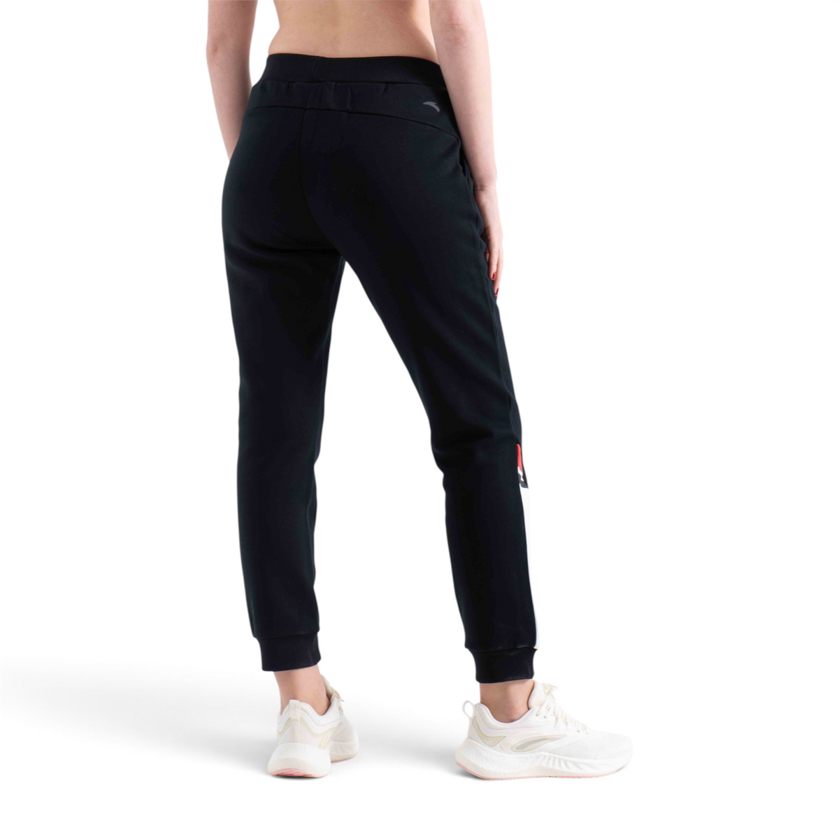 FRG regular fit black knit track pants with cuffed ankles worn by a woman from the back view