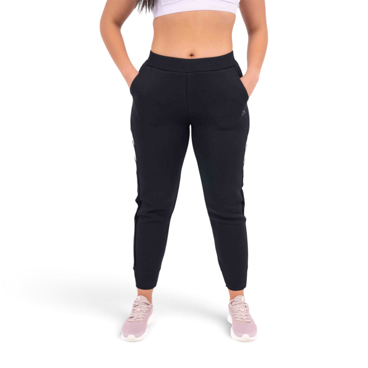 FRG black regular fit knit track pants with side stripes worn by a model with pink sneakers