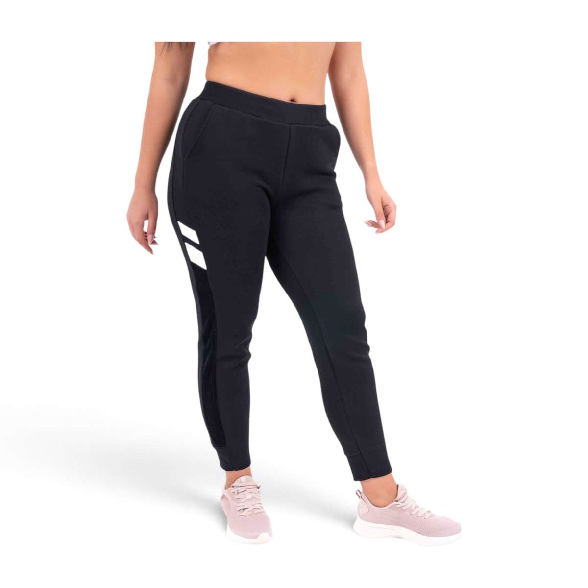 FRG black knit track pants with white side stripe detail and regular fit, worn by a model with pink sneakers.