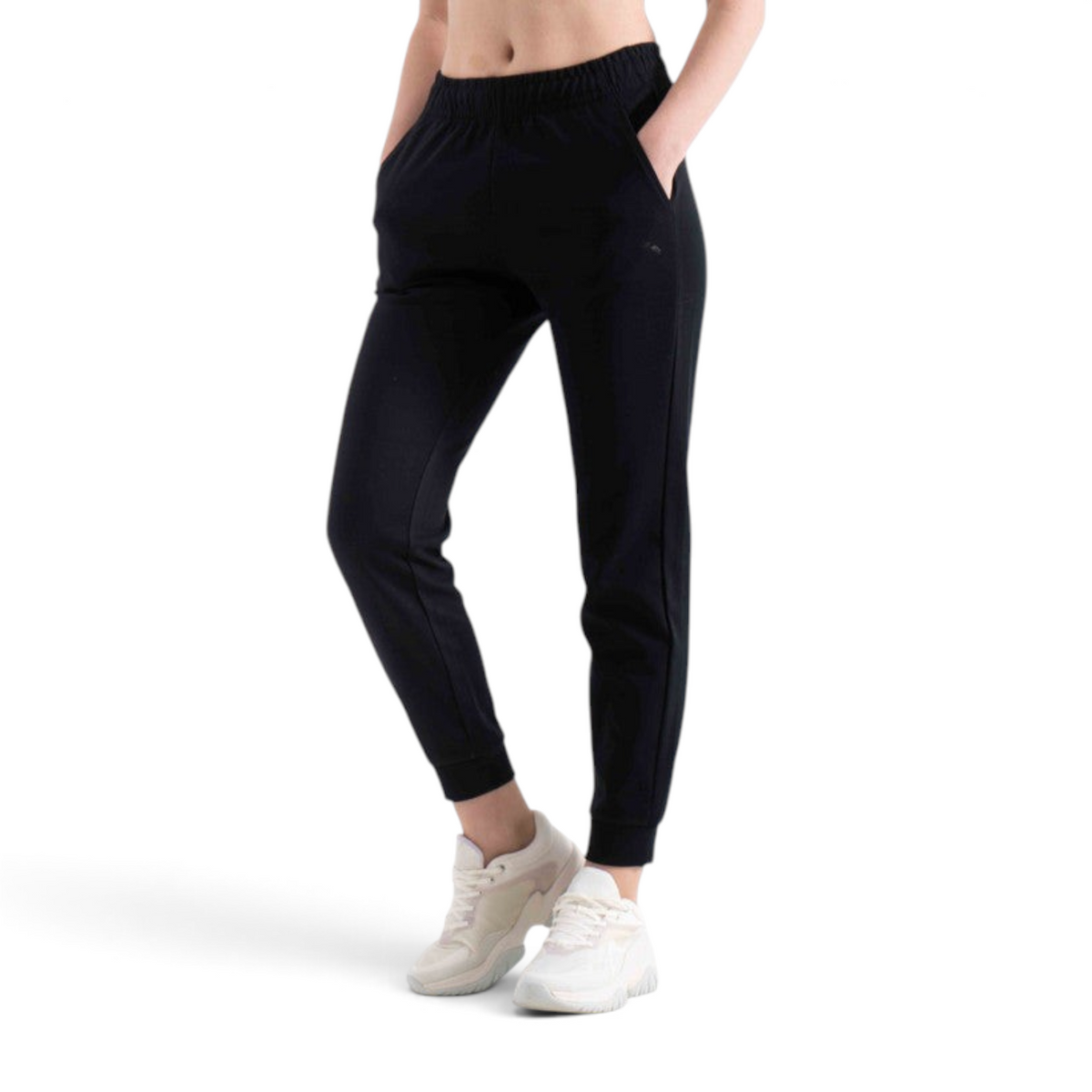 FRG black knit track pants with an elastic waistband and cuffed ankles worn by a model with white sneakers