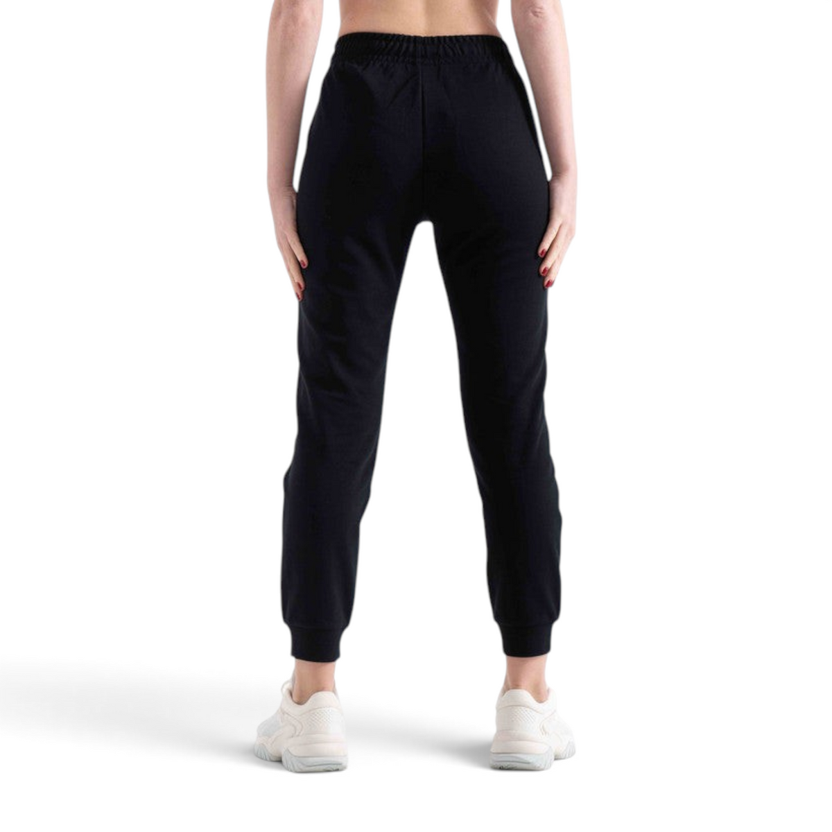 Back view of FRG black knit track pants with an elastic waistband and cuffed ankles worn by a model