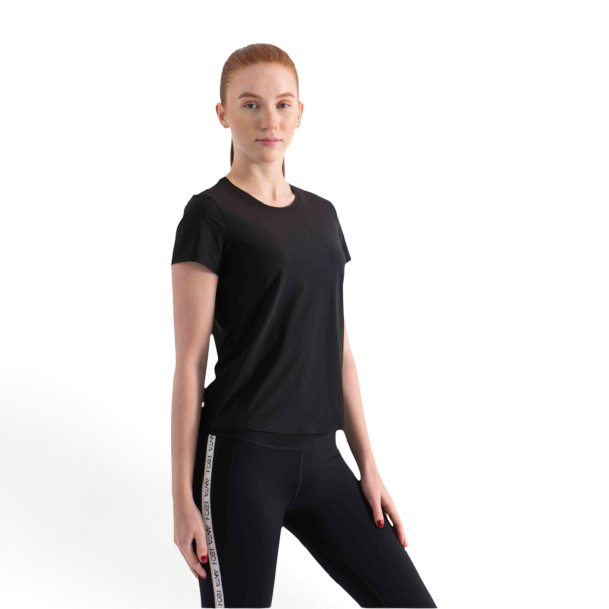 FRG black short sleeve athletic t-shirt worn by a woman with red hair against a white background