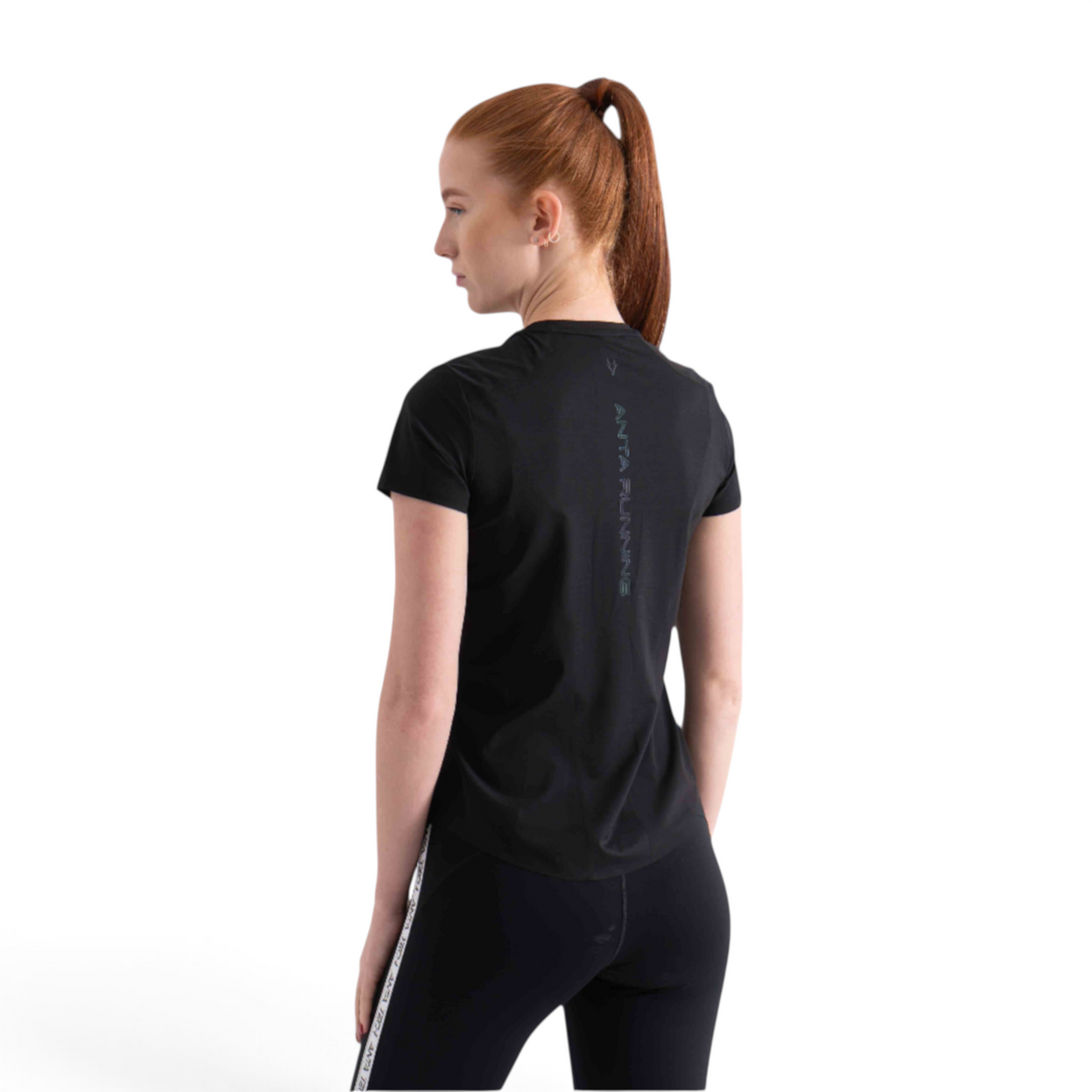 FRG black short sleeve running t-shirt with reflective back detailing worn by a woman with a ponytail