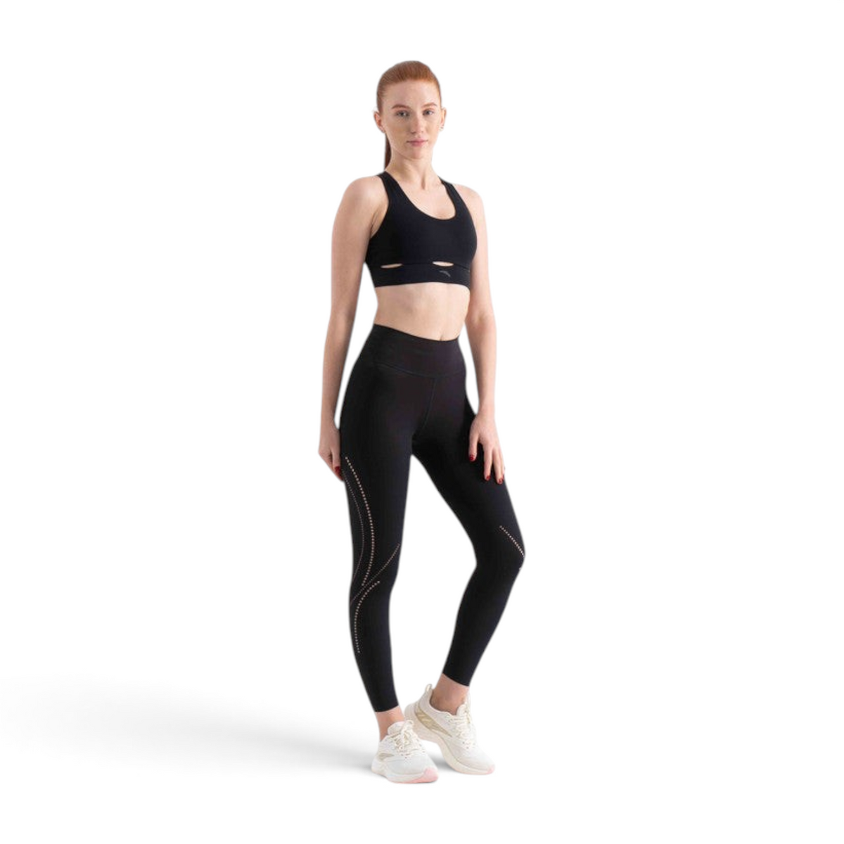 FRG model wearing a black athletic sports bra and matching high-waisted leggings with side laser-cut detailing