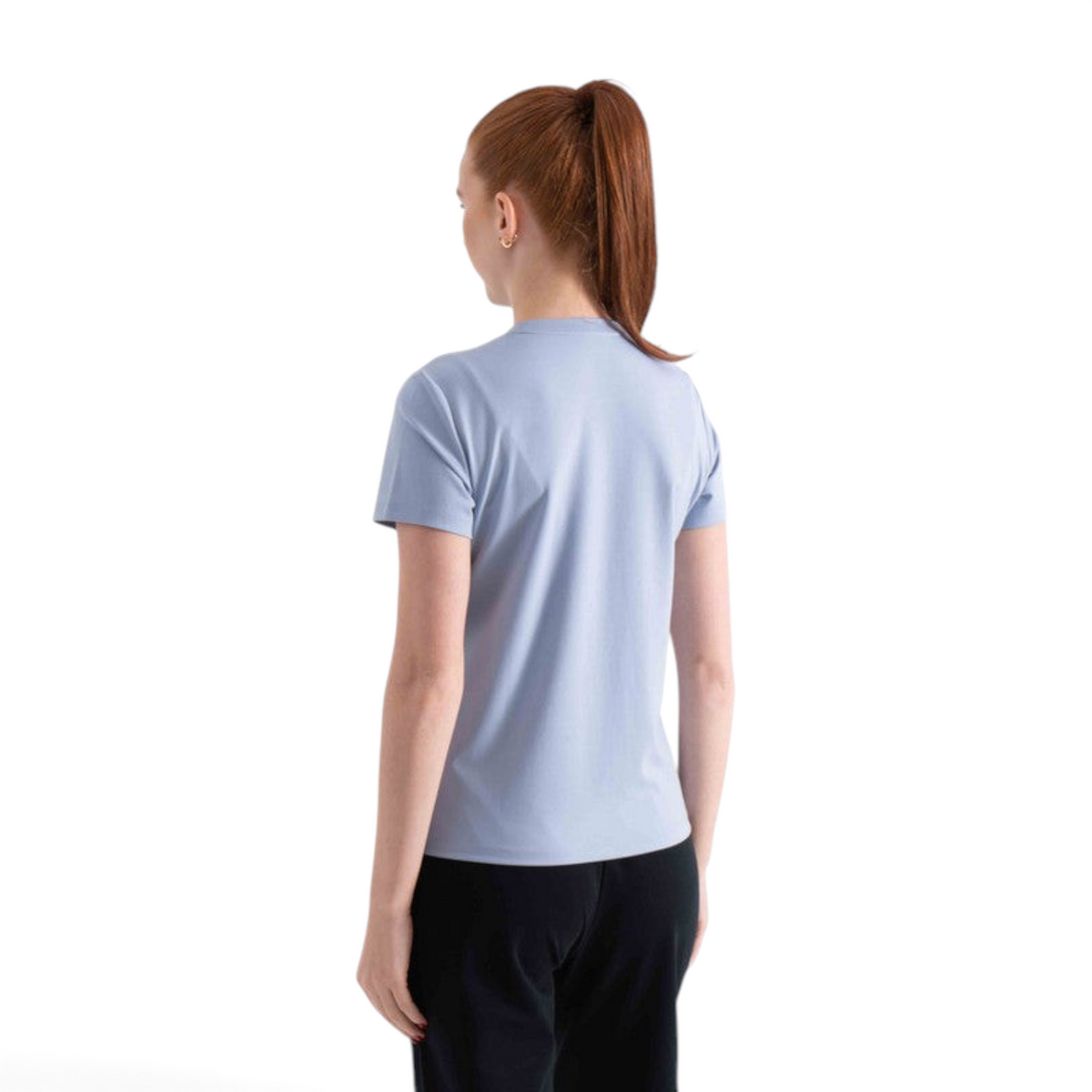 Back view of a woman wearing a light blue FRG SS TEE short sleeve shirt with a crew neck, isolated on white.