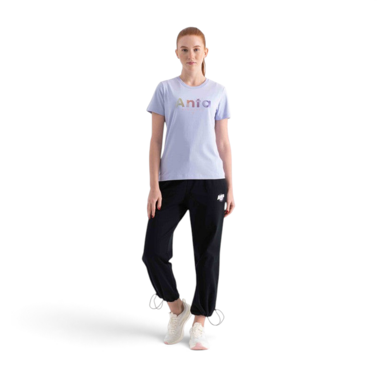 FRG SS TEE in light purple with a rainbow metallic logo, paired with black joggers and white sneakers on a model.