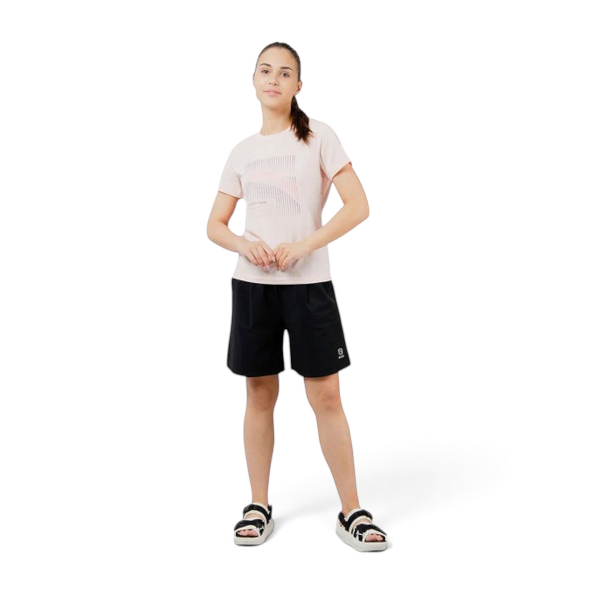 FRG model wearing an ANTA fog rose pink cotton-blend short sleeve training t-shirt with black shorts and sandals