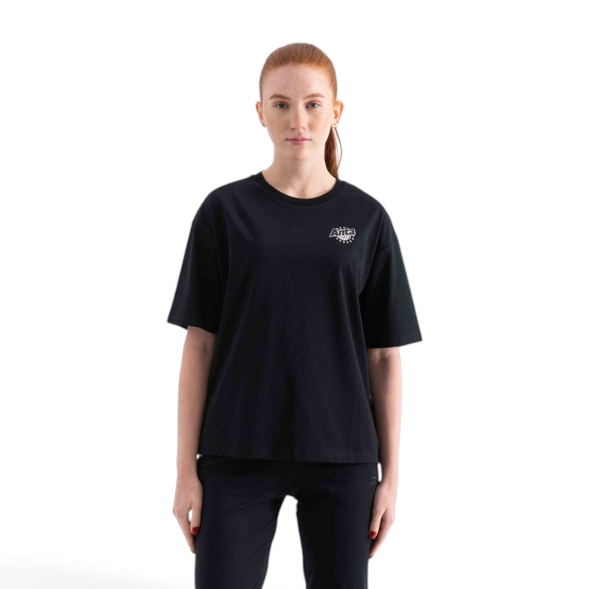 FRG black short sleeve t-shirt with a small white graphic logo on the chest worn by a woman