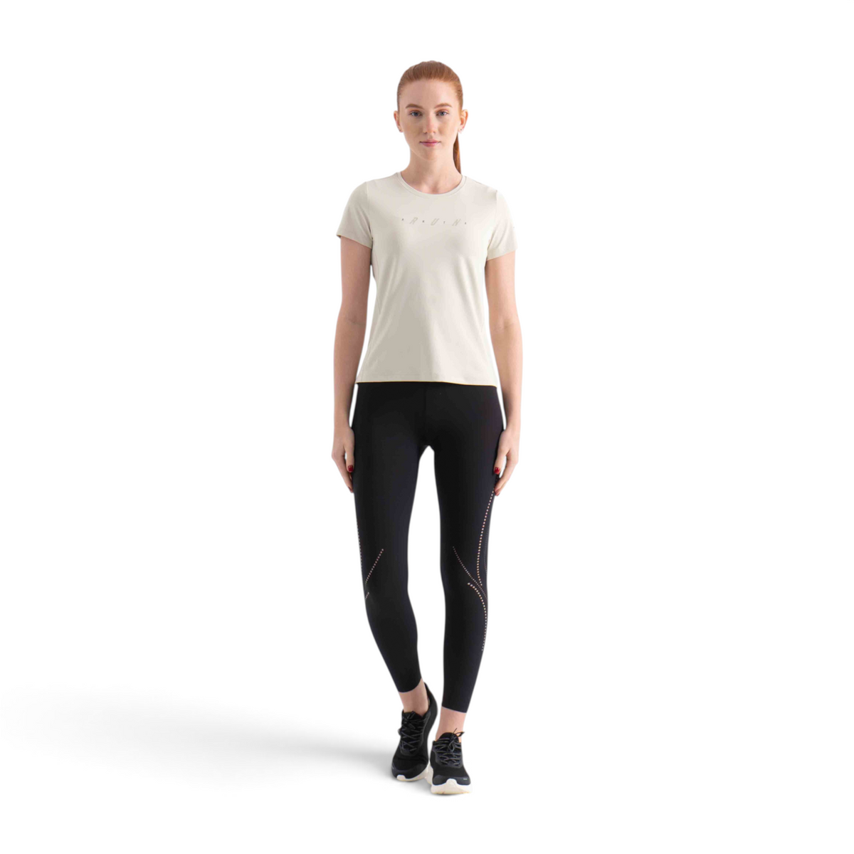 FRG SS TEE in beige with RUN graphic, worn by a model with black leggings and sneakers against a white background