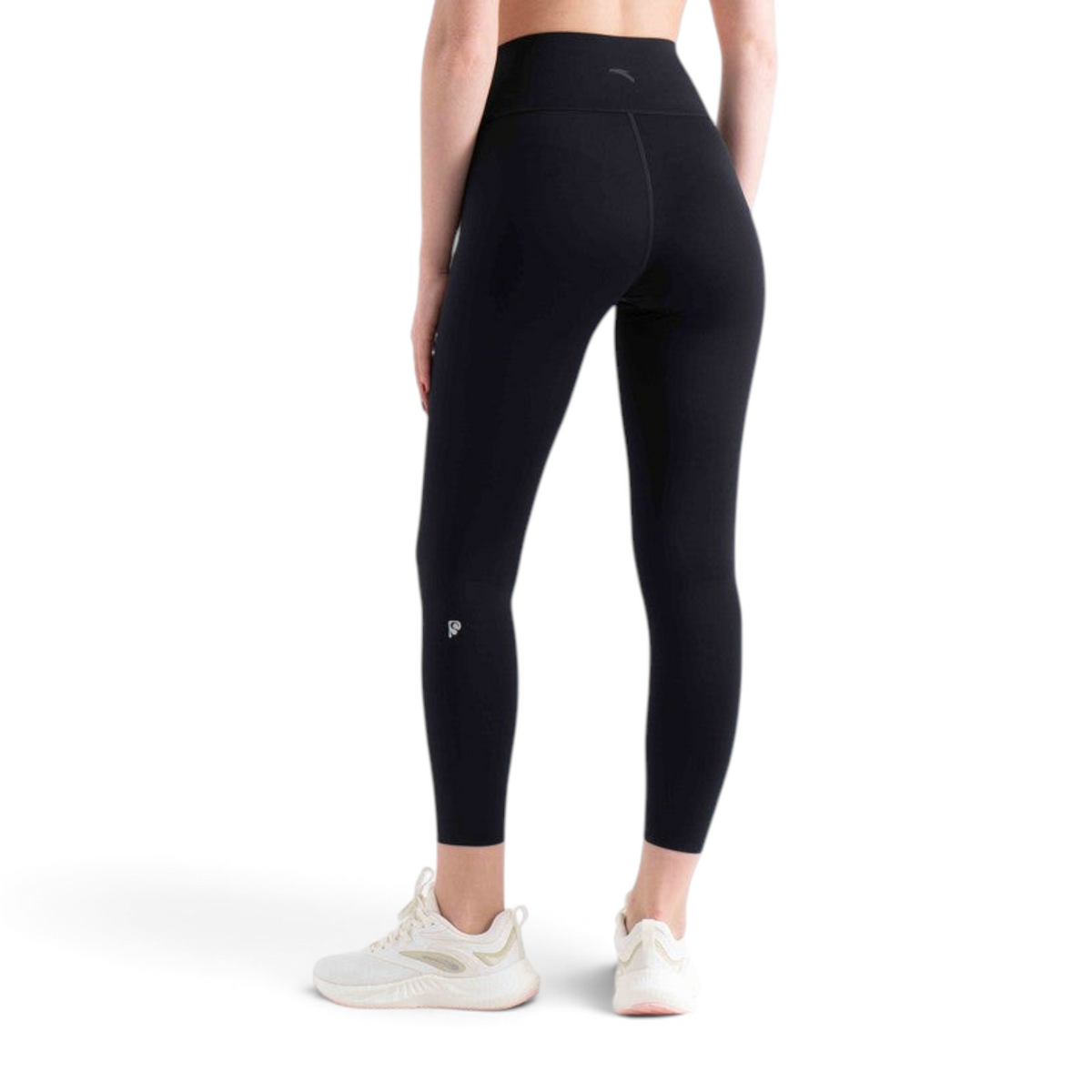 FRG tight ankle pants in black, featuring a high-waisted fit and athletic design, worn with white sneakers.