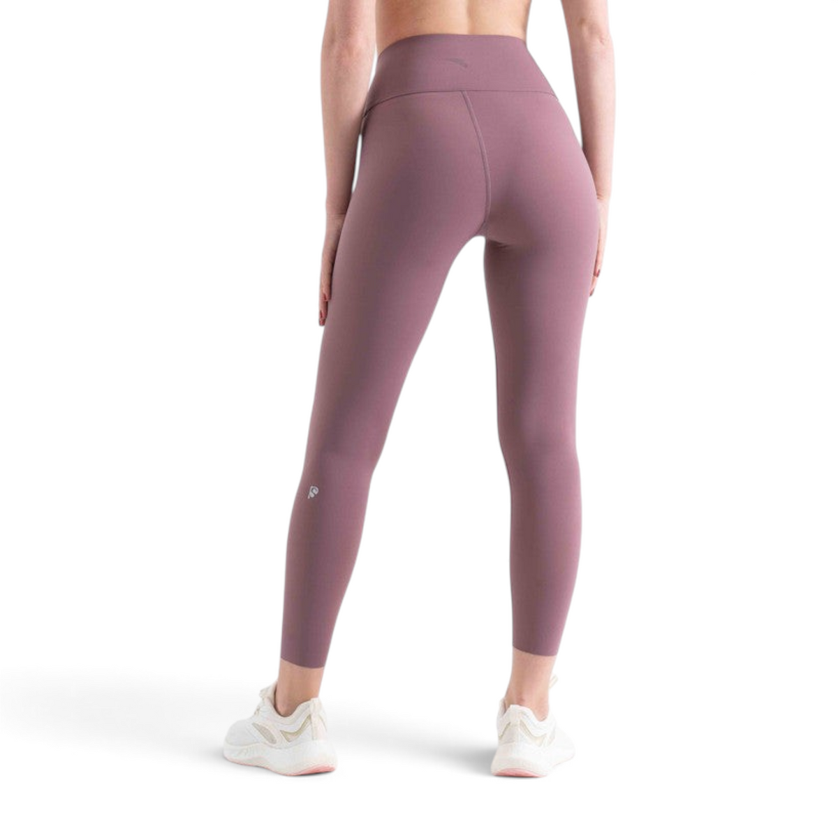 Rear view of a person wearing FRG mauve high-waisted tight ankle pants with white athletic sneakers