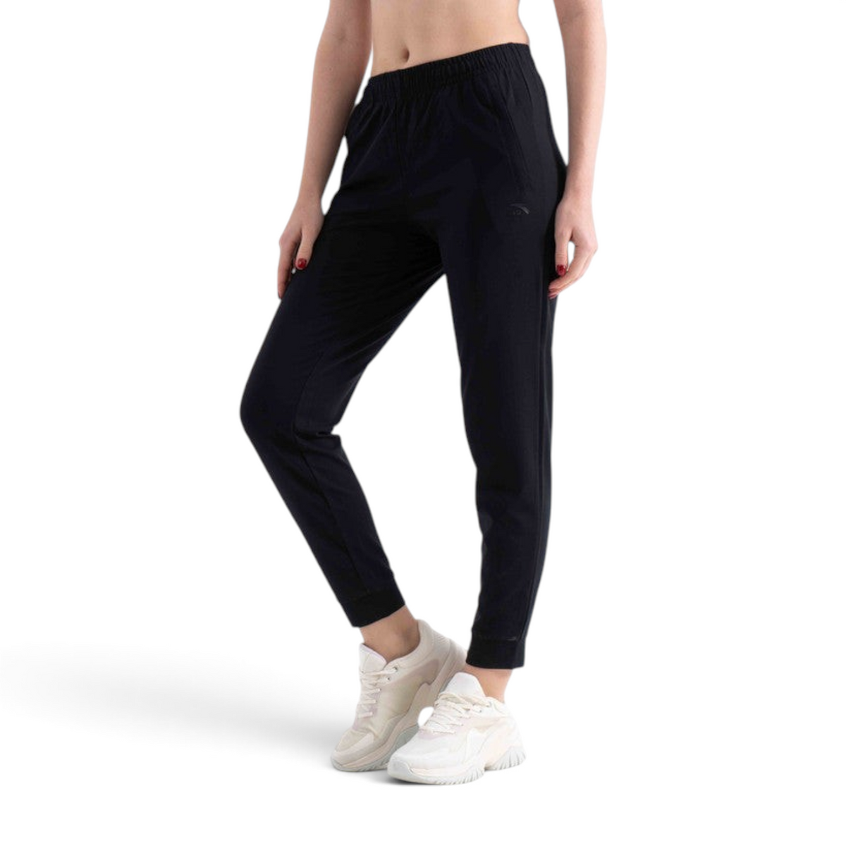 A model wearing FRG black knit track pants with an elastic waistband and cuffed ankles against a white background.