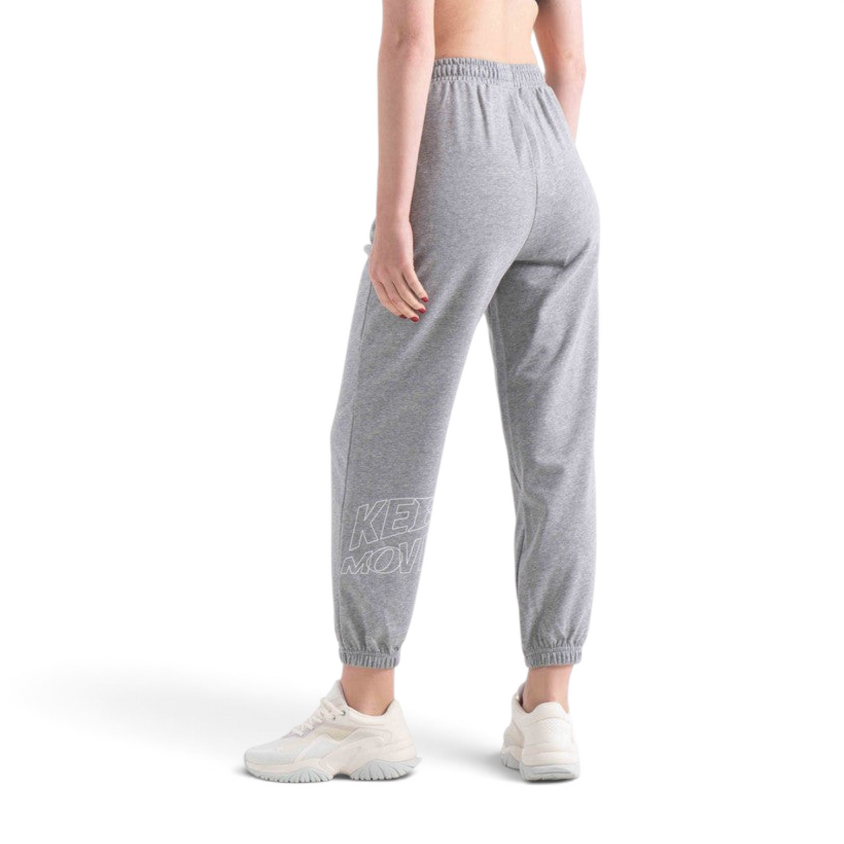 FRG women's grey knit track pants with elasticated cuffs and white graphic detail, worn with white sneakers.