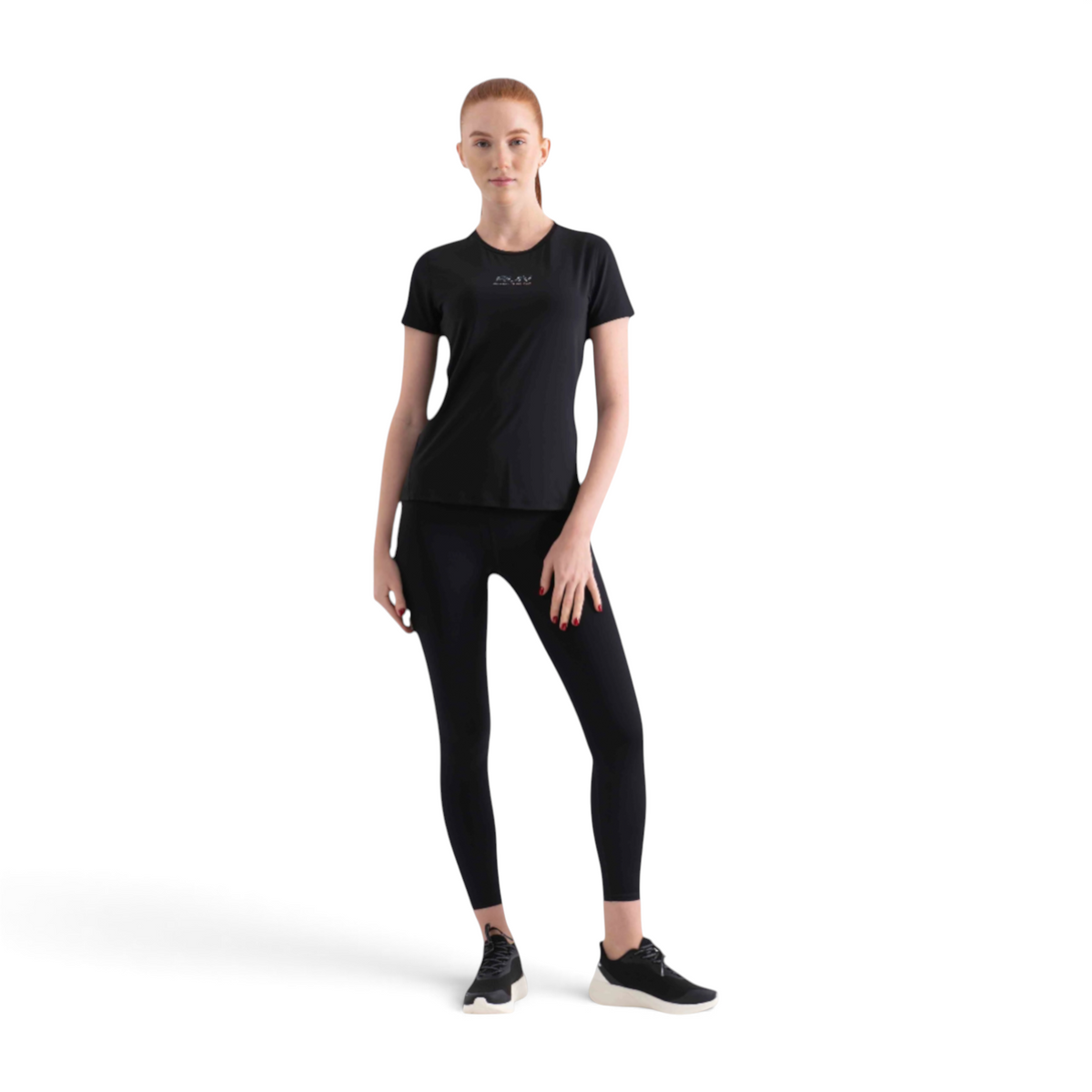 A woman wearing a black FRG short-sleeve athletic t-shirt and matching black leggings against a white background.