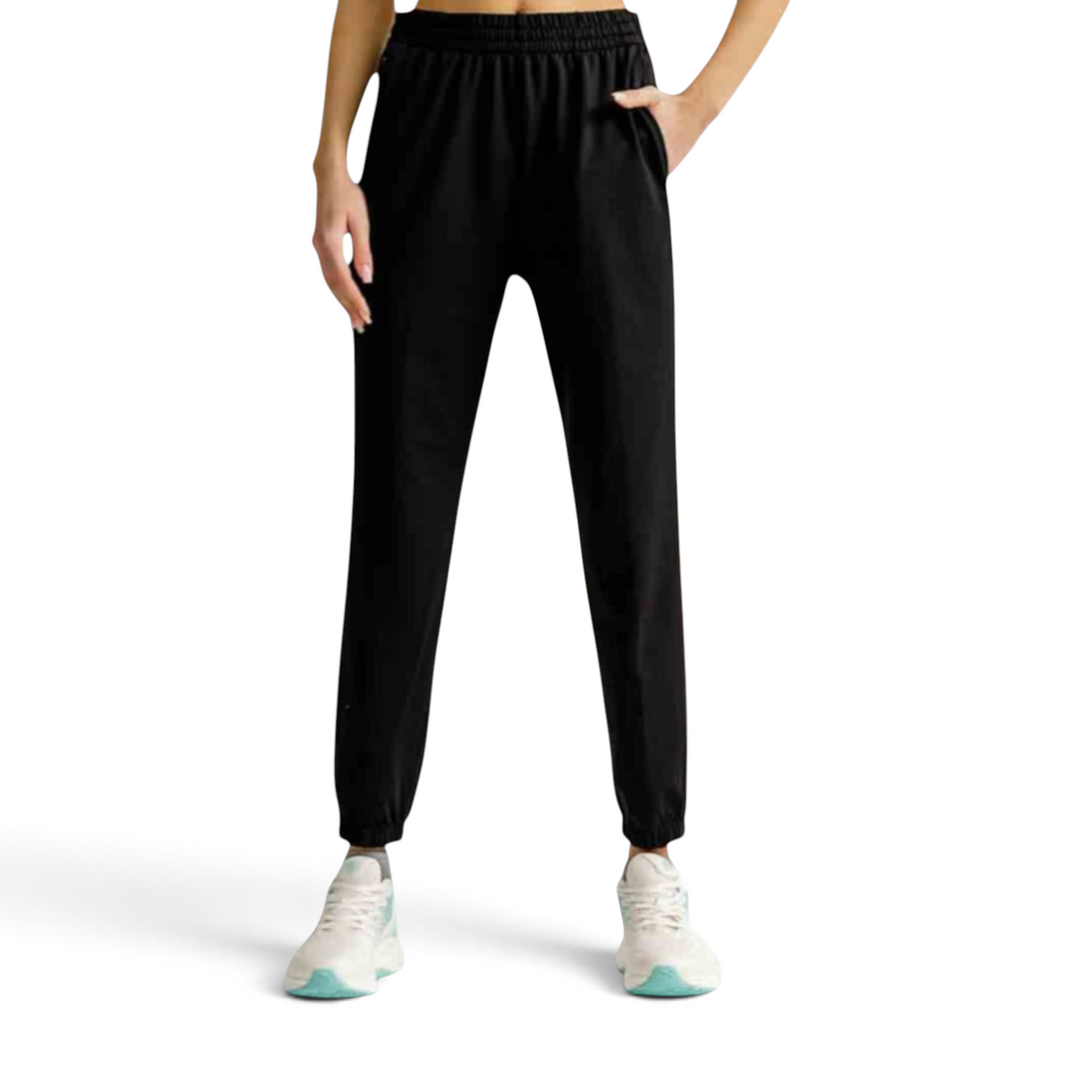 FRG black knit track pants with an elastic waistband and cuffed ankles worn by a model with white sneakers