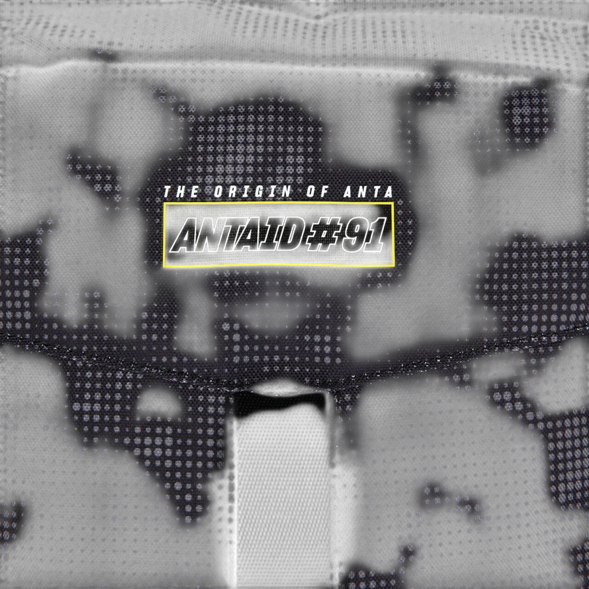 FRG backpack featuring a black fabric with a subtle grey dot pattern and a yellow rectangular logo patch